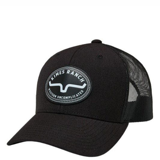 Black trucker cap with a round leather logo patch on the front.